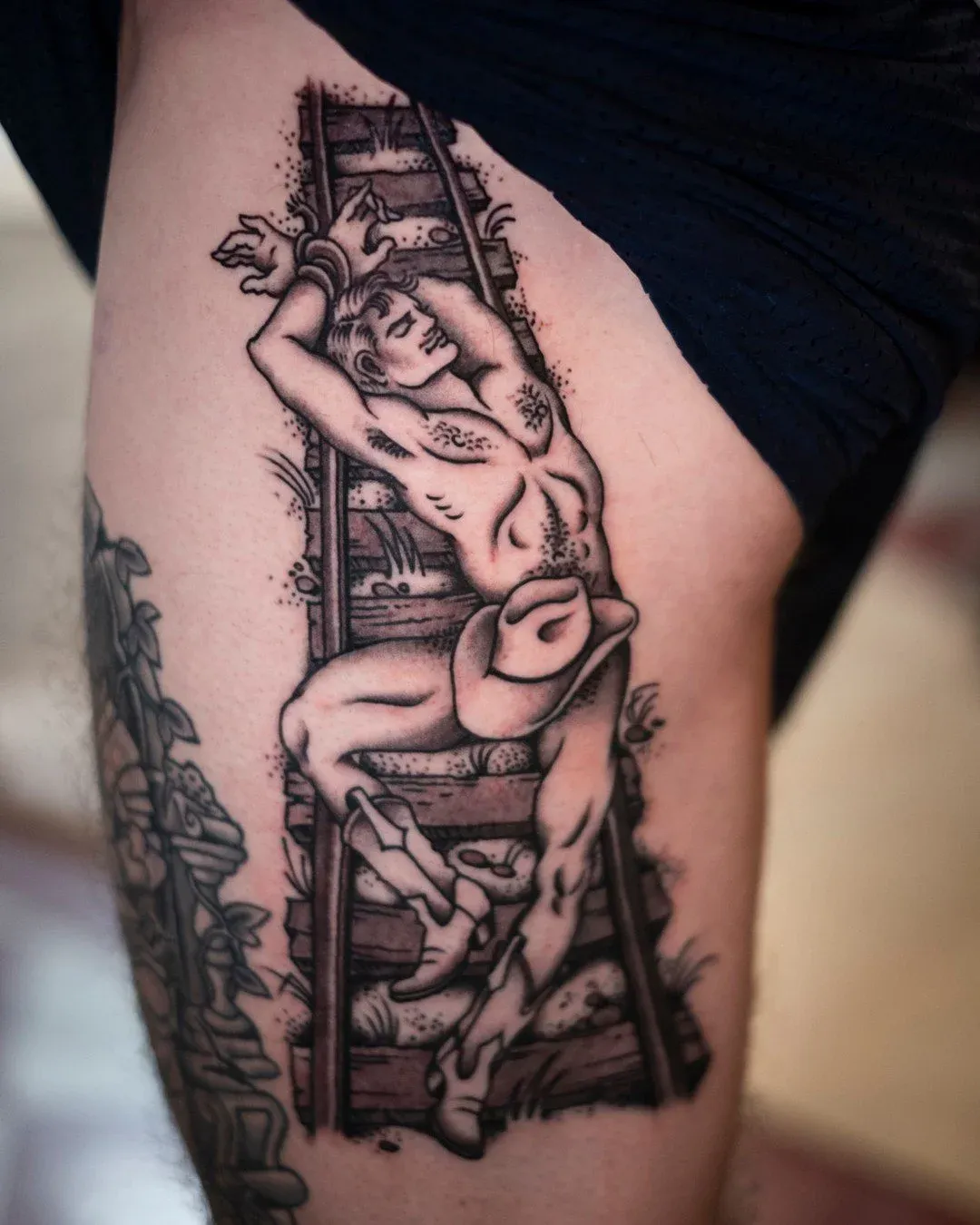 Blackwork tattoo of woman and ladder on thigh by Dan Gilsdorf, tattoo artist in Portland, Oregon