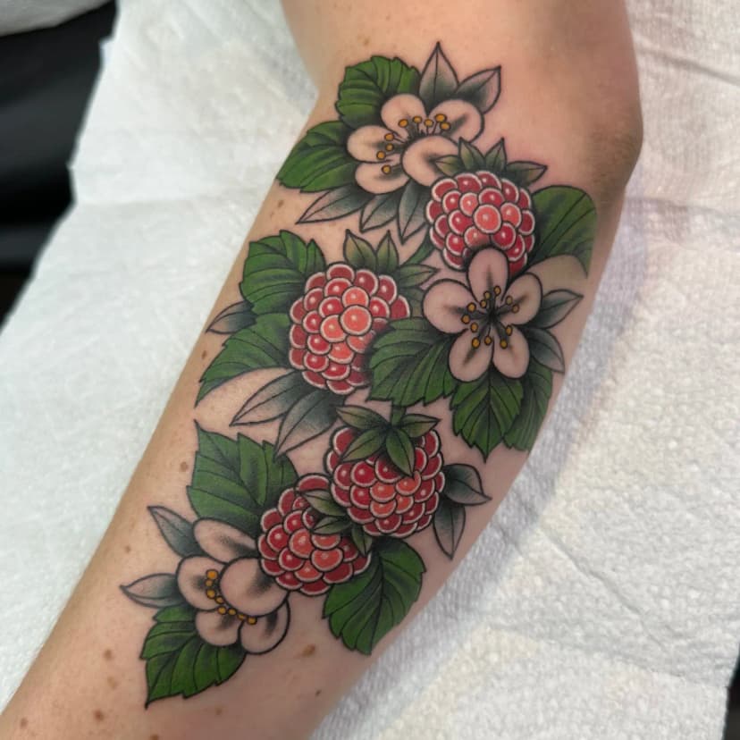 Traditional tattoo of flowers and berries on forearm by Dev Renee, tattoo artist in Portland, Oregon