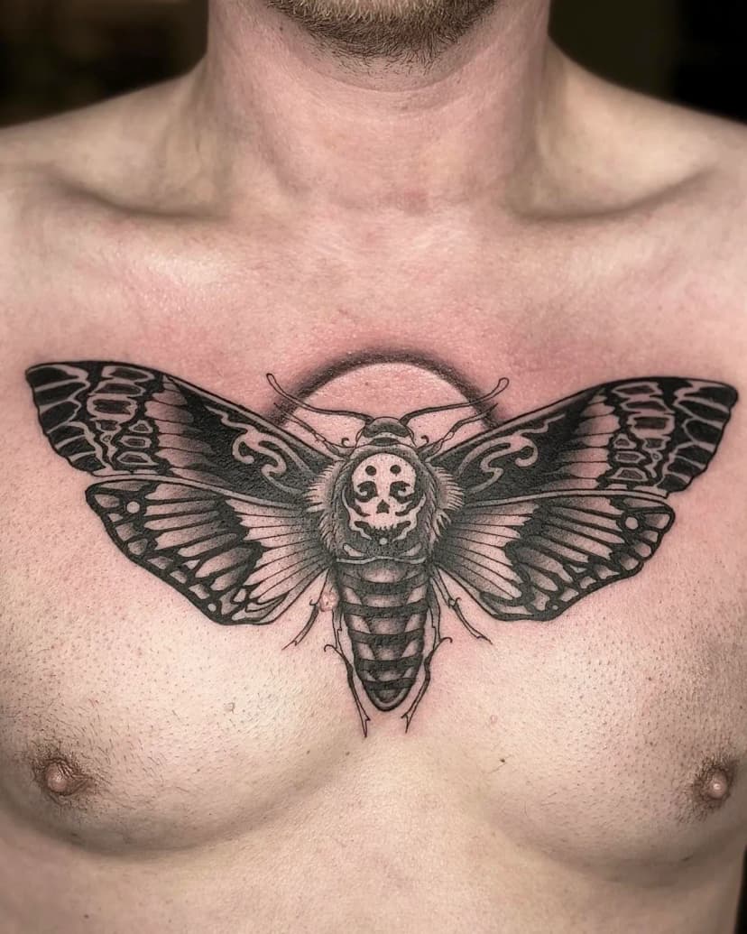 Blackwork tattoo of moth on chest by Ellie Chase, tattoo artist in Portland, Oregon