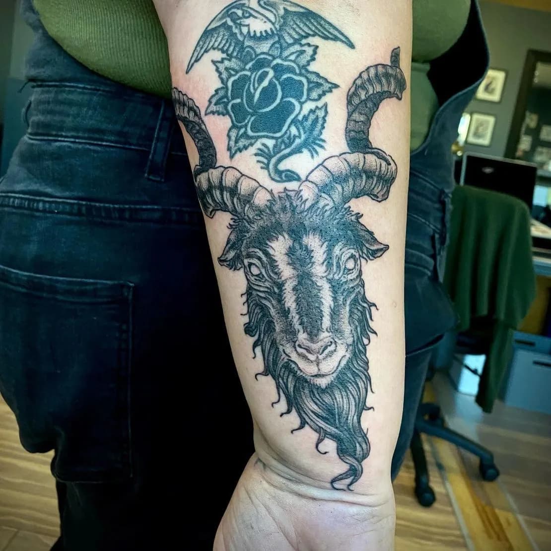 Blackwork tattoo of goat and rose on forearm by Ian McVay, tattoo artist in Portland, Oregon