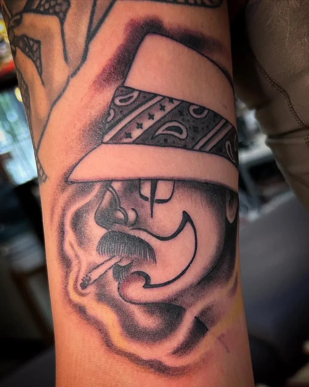 Chicano tattoo of cholo face and bandana on forearm by Jerry Ware, tattoo artist in Portland, Oregon