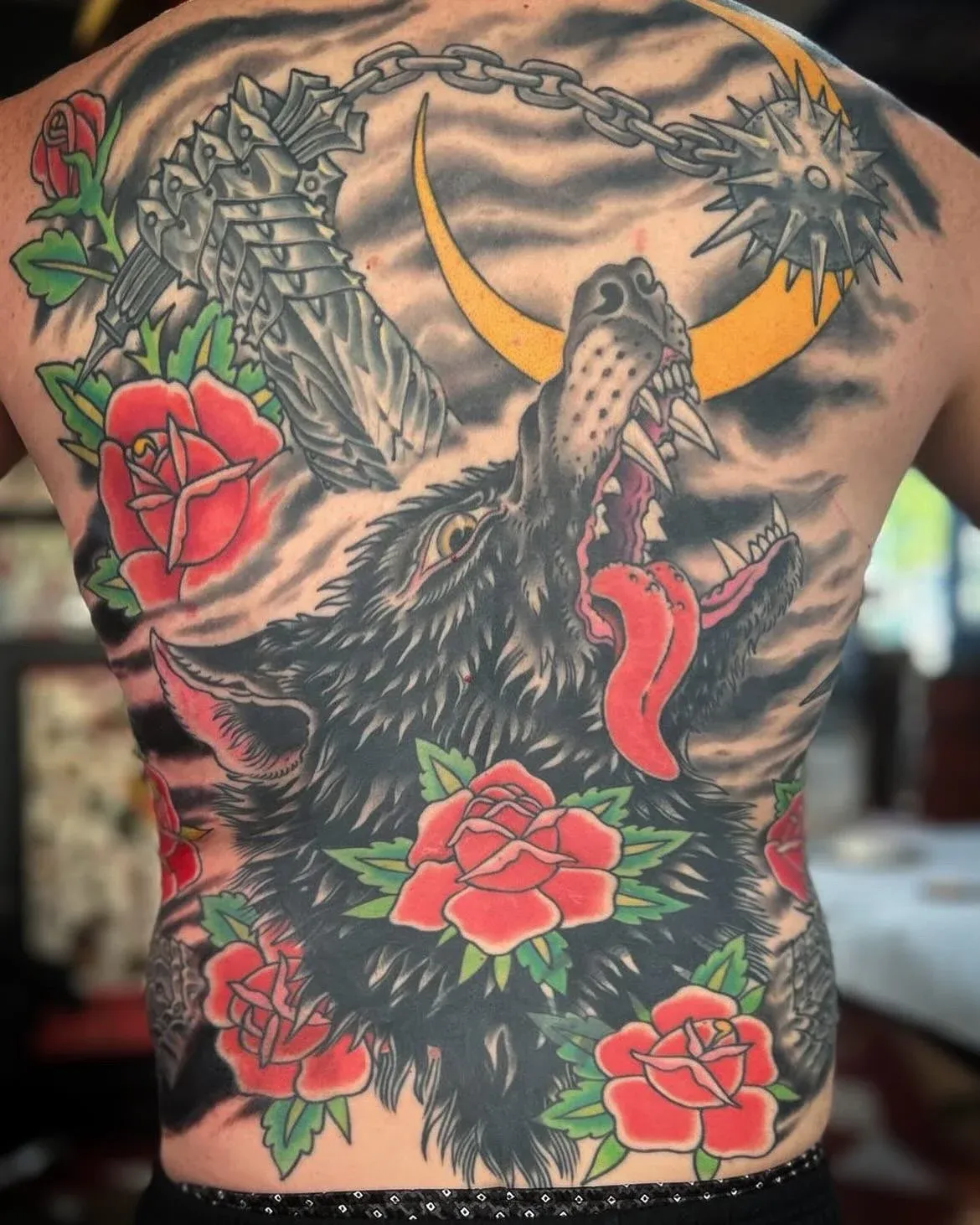 Traditional tattoo of wolf and roses on back by Jerry Ware, tattoo artist in Portland, Oregon