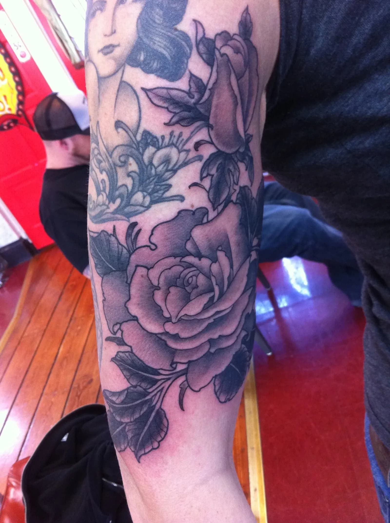 Neo-traditional tattoo of rose and woman on forearm by Lewis Hess, tattoo artist in Portland, Oregon
