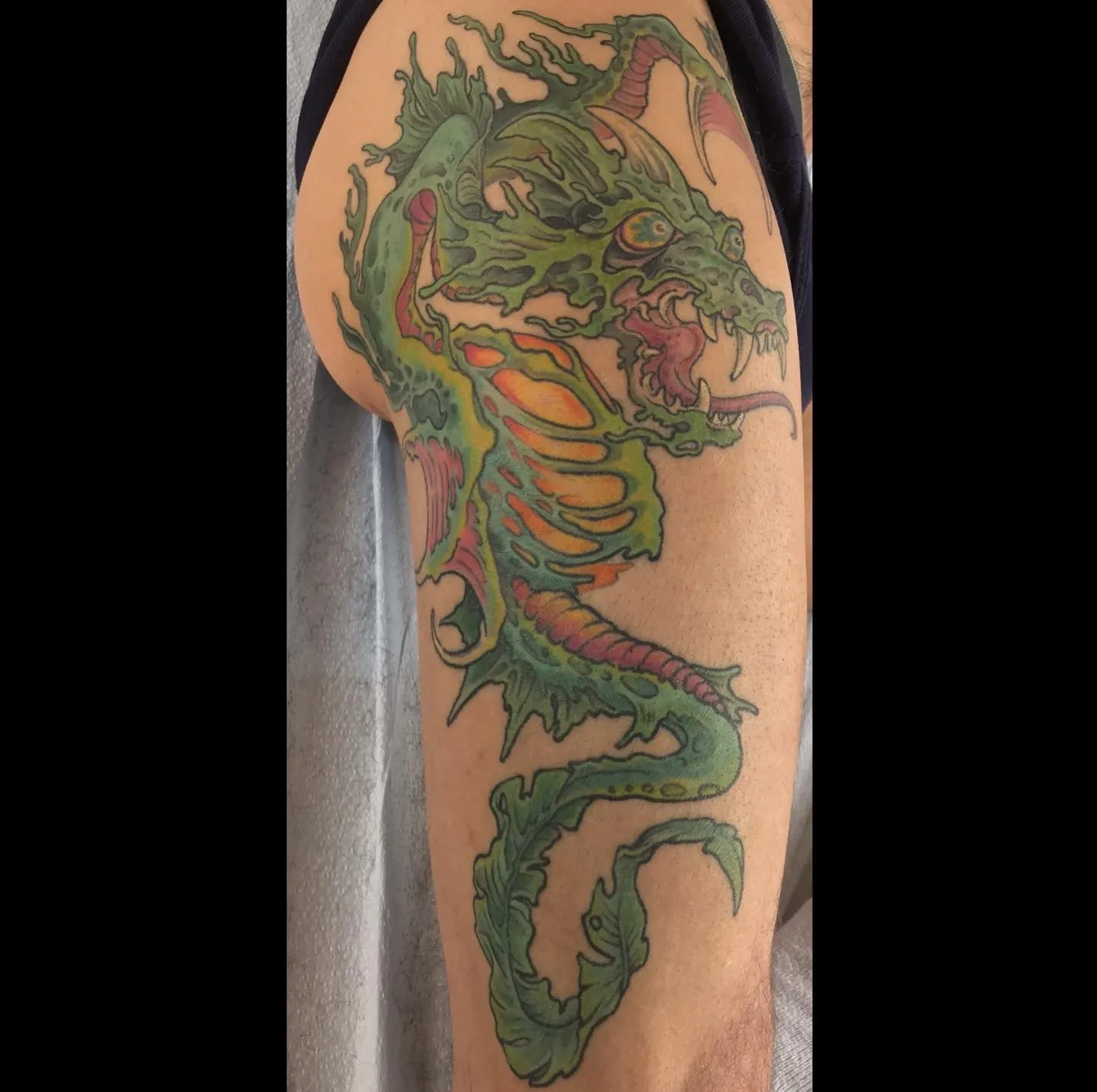 Neo-traditional tattoo of dragon on thigh by Matt Reed, tattoo artist in Portland, Oregon