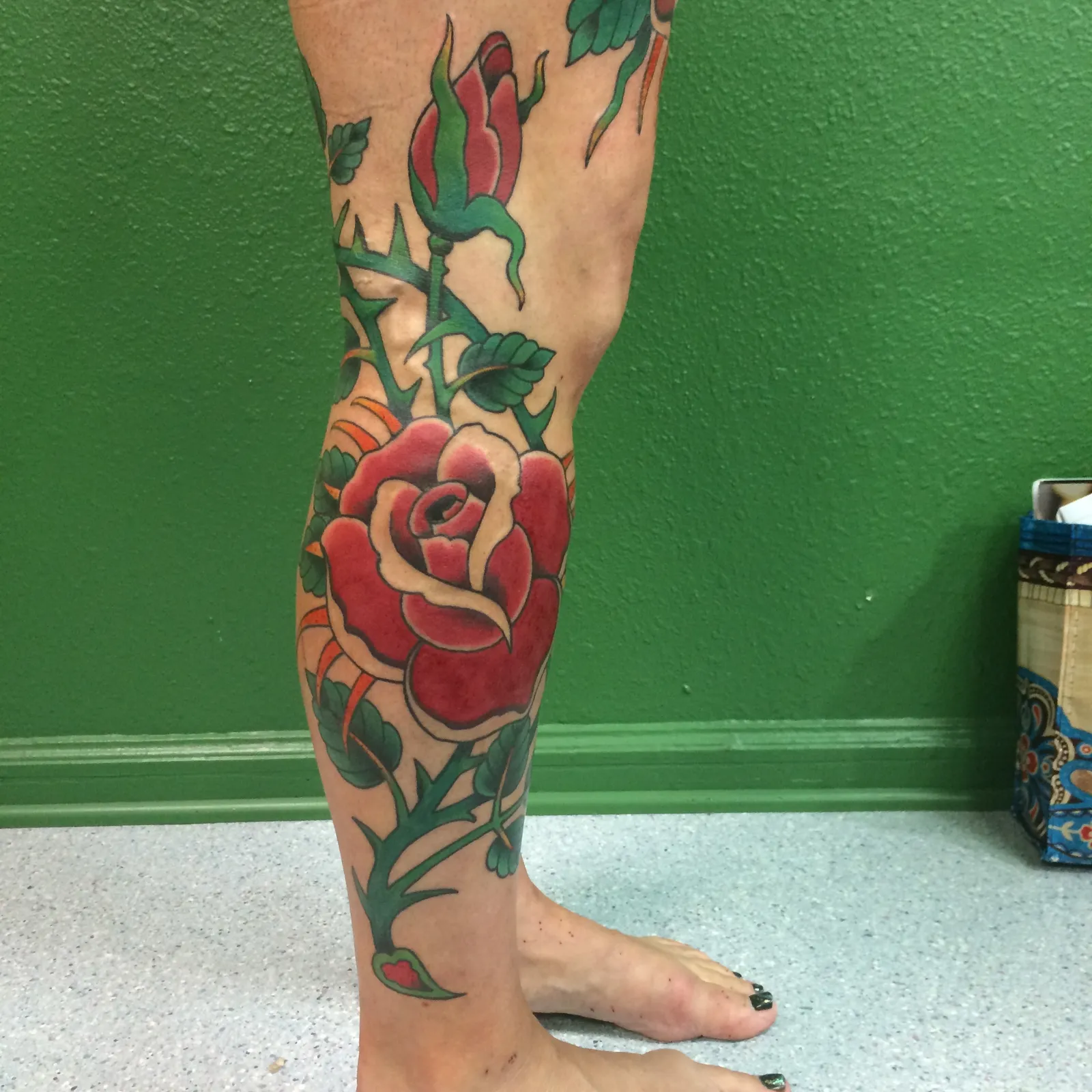 Neo-traditional tattoo of rose and thorns on leg by Mav Mess, tattoo artist in Portland, Oregon