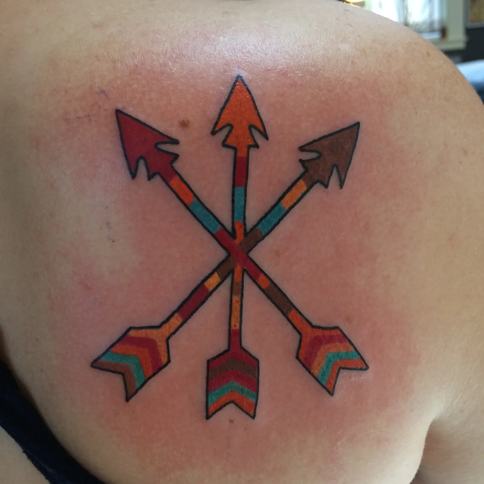 Traditional tattoo of arrows on back by Mav Mess, tattoo artist in Portland, Oregon