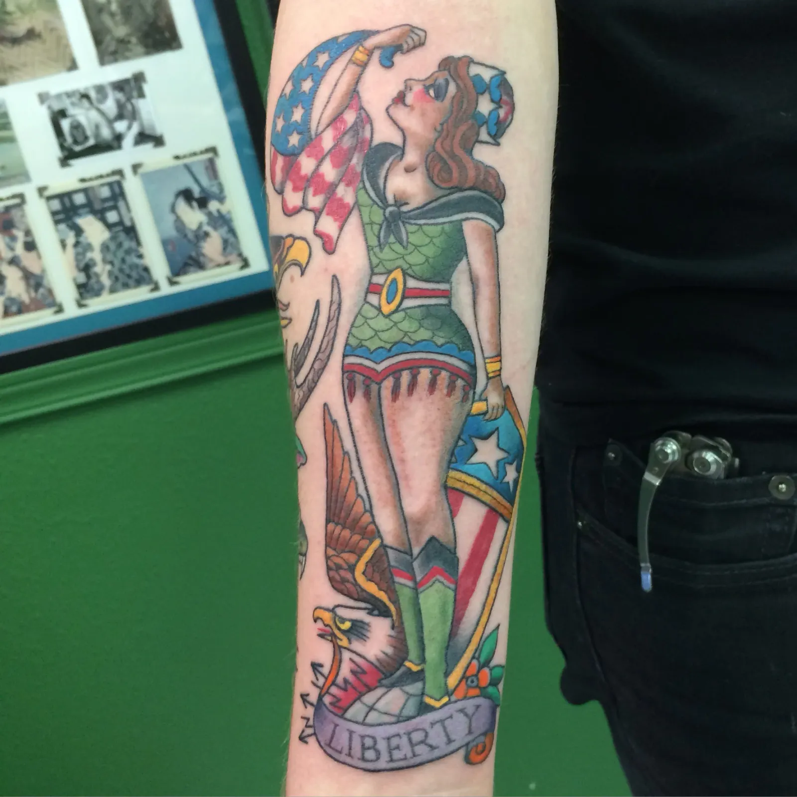 Traditional tattoo of pin-up girl and eagle on forearm by Mav Mess, tattoo artist in Portland, Oregon