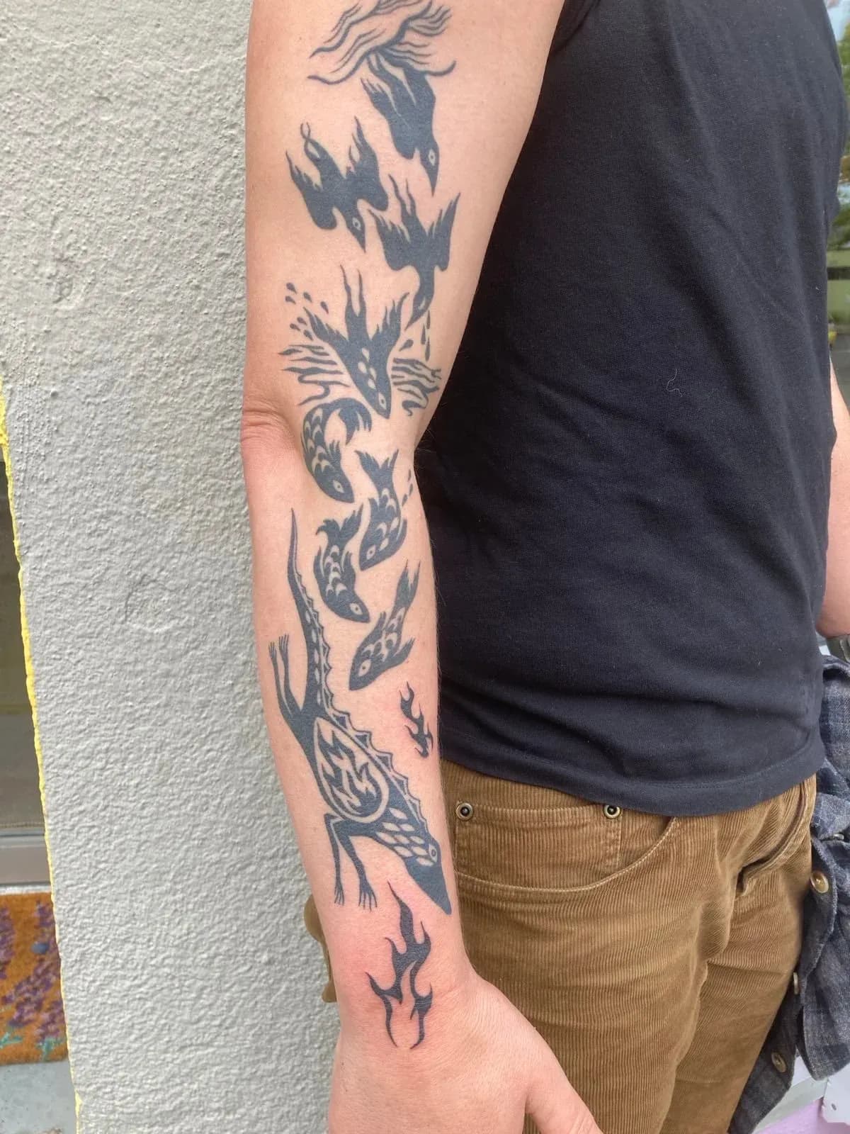 Blackwork tattoo of dragon and koi on forearm by Riversteeth, tattoo artist in Portland, Oregon