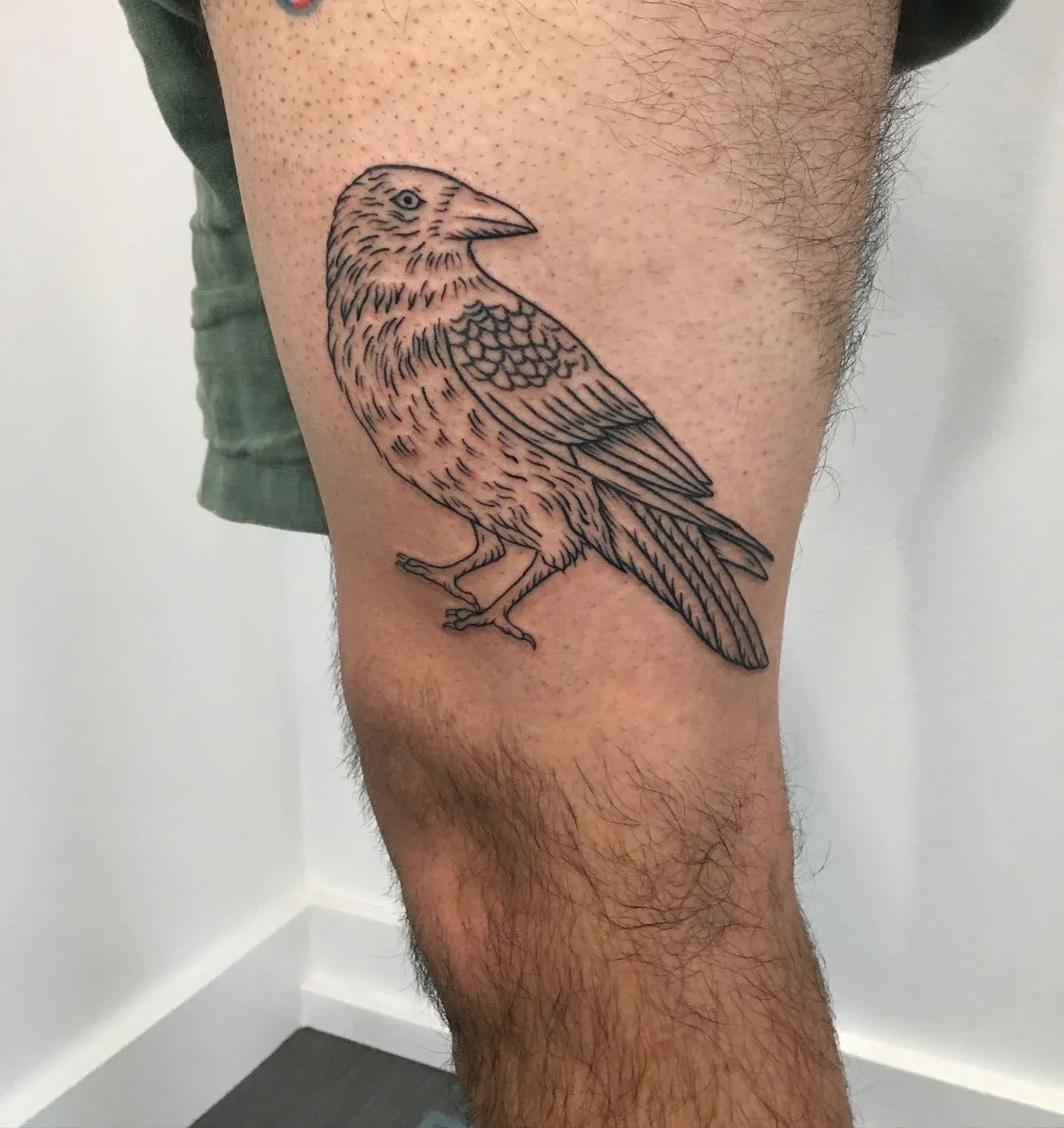 Blackwork tattoo of raven on leg by Riversteeth, tattoo artist in Portland, Oregon