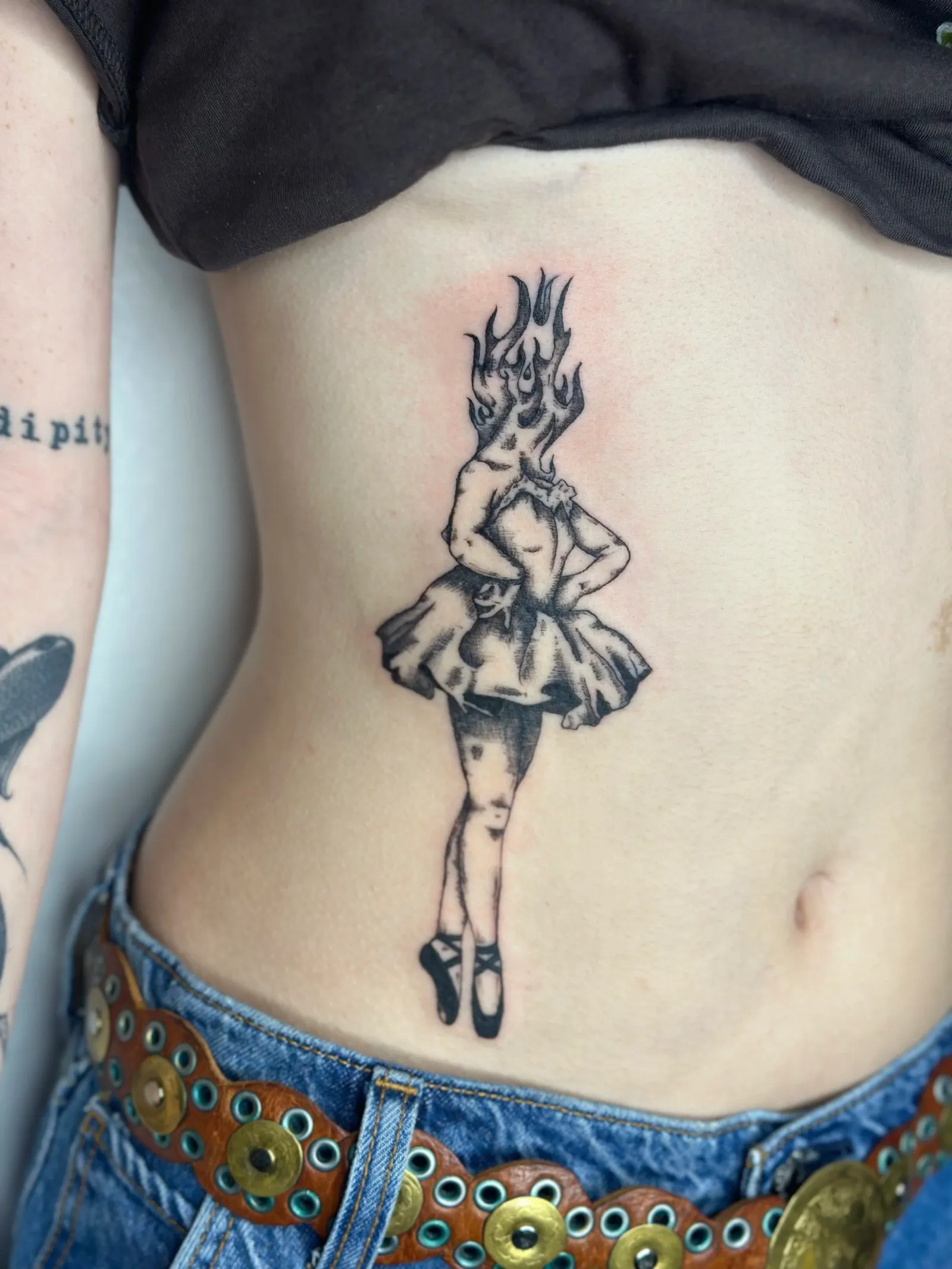 Illustrative tattoo of ballerina and fire on back by Sadie, tattoo artist in Portland, Oregon