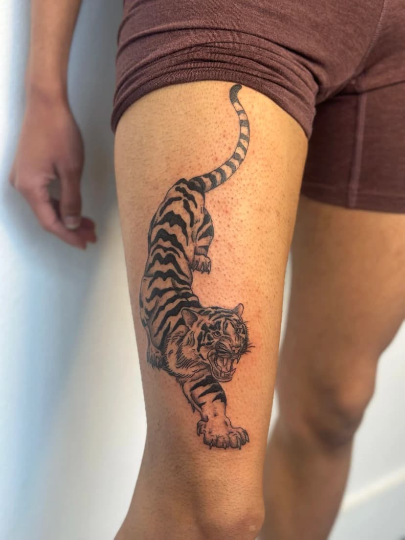 Illustrative tattoo of tiger on thigh by Sadie, tattoo artist in Portland, Oregon