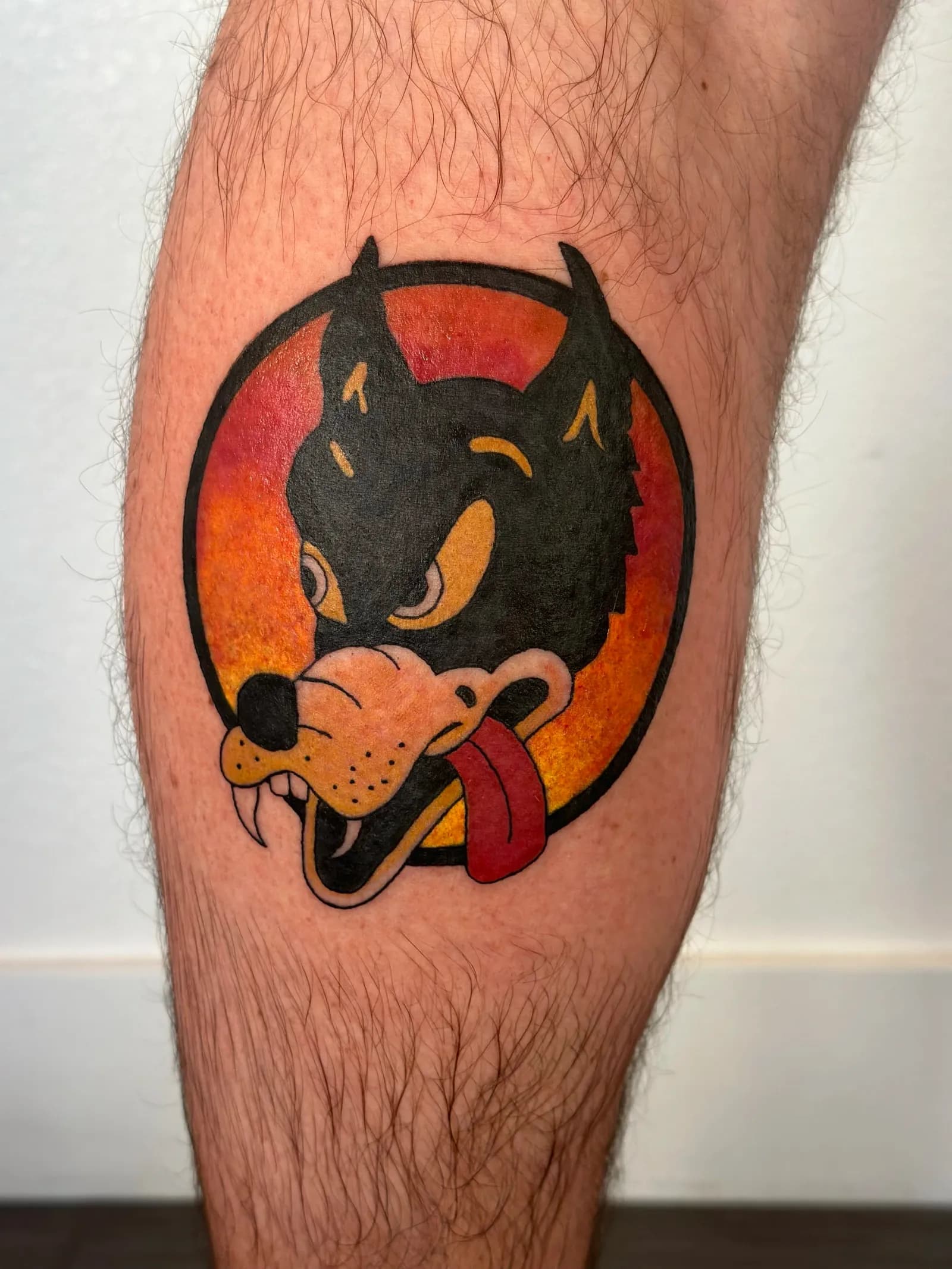 Neo-traditional tattoo of devil dog on calf by Sadie, tattoo artist in Portland, Oregon