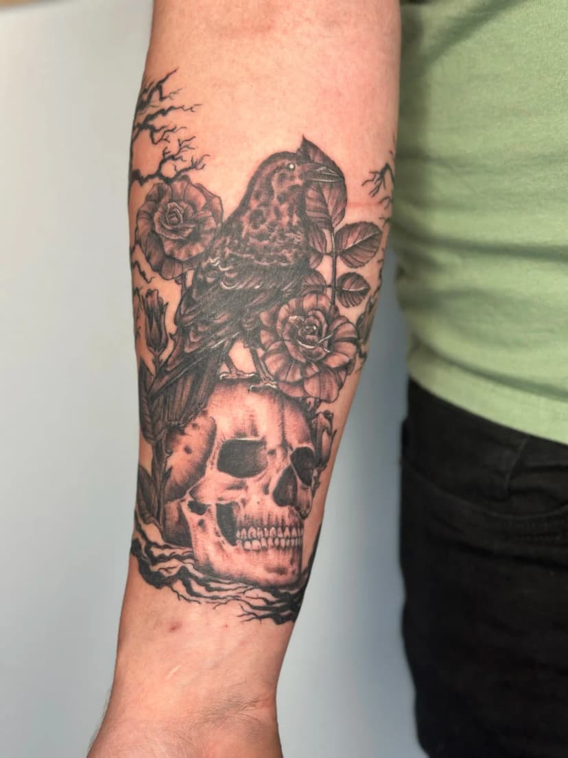 Realism tattoo of skull and raven on forearm by Sadie, tattoo artist in Portland, Oregon